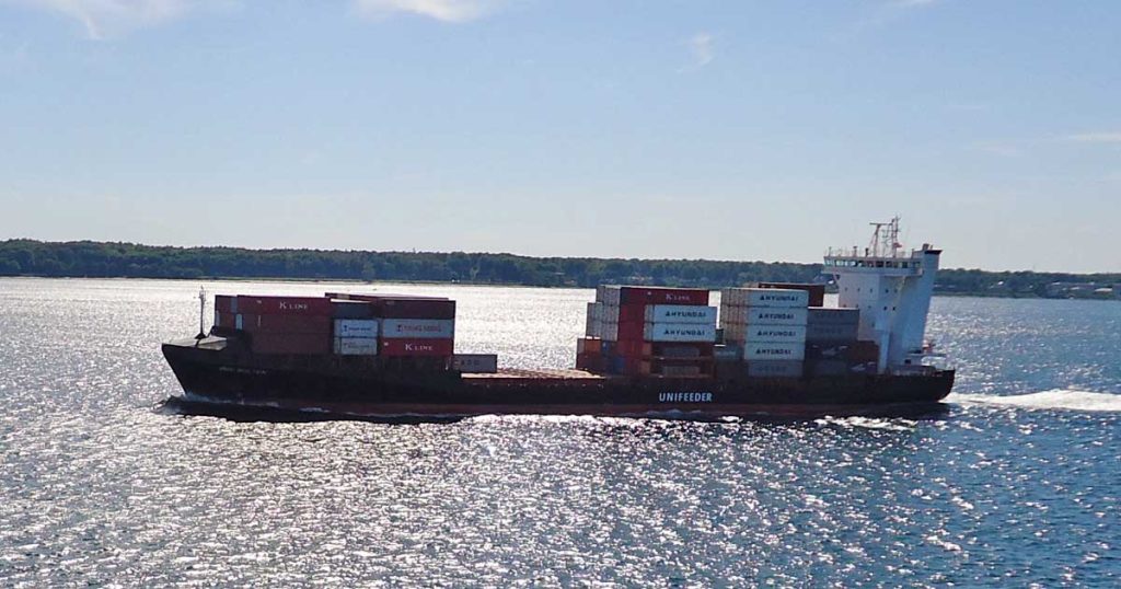 A power driven cargo vessel navigating in broad daylight. She is not displaying any day shape.
